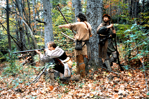 (L to R): Randy Kiddy takes aim as Ron Phelps and Mike Clemons back him up during a hostile scout in
the mountainous Jefferson National Forest of western Virginia. A good basic understanding of the 18th
century borderman helps these three to more correctly "step into" their time period with an absolute
minimum of errors and guess work.<br> Photo: Dale Payne.